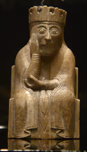 **Lewis chessman**

Exhibition in the National Museum of Scotland. Pieces from the British Museum, National Museum of Scotland and other collections. A queen with number of permanent collection NMS 21
[Source](https://commons.wikimedia.org/wiki/File:Lewis_chessmen_26.JPG)